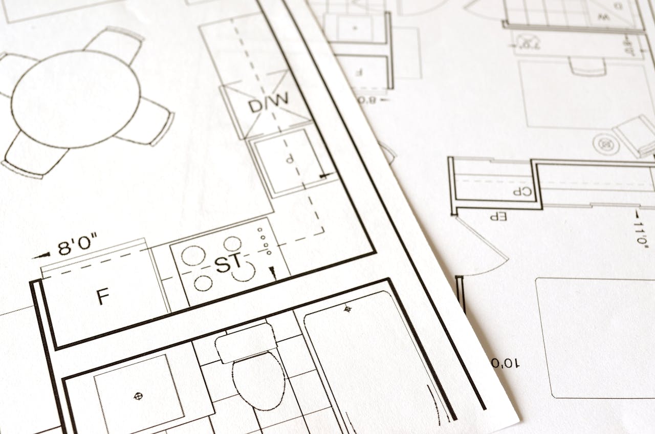 Home Close-up view of an architectural floor plan on paper showcasing detailed room layouts and measurements.